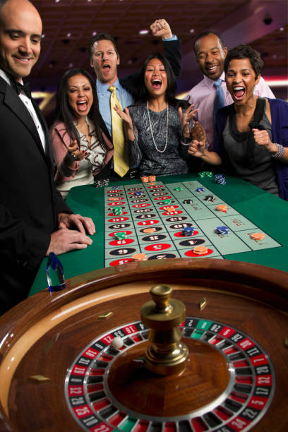 Live baccarat dealer at slotdadu studio, multiple camera angles showing shoe, cards, and betting table